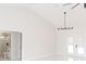 Bright, neutral living room with sleek tile floors, modern lighting, and bathroom entrance at 8878 Sw 133Rd Lane Rd, Ocala, FL 34473