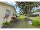 The backyard is spacious with mature landscaping, and a healthy lawn; a large tree provides ample shade at 9015 Sw 94Th St # D, Ocala, FL 34481