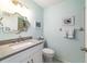 Bright bathroom featuring a uniquely-framed mirror, neutral countertops and light blue walls at 9015 Sw 94Th St # D, Ocala, FL 34481