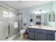 Bright bathroom features a walk-in shower, vanity with storage, and fresh decor at 9015 Sw 94Th St # D, Ocala, FL 34481