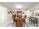 Bright dining area features a wooden table, four chairs, and a built-in china cabinet, seamlessly connecting to the kitchen at 9015 Sw 94Th St # D, Ocala, FL 34481