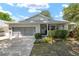 Charming single-story home with a brick facade, well-manicured lawn, and a two-car garage at 9015 Sw 94Th St # D, Ocala, FL 34481