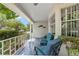 Comfortable covered front porch with blue seating, brick columns and an attractive white railing at 9015 Sw 94Th St # D, Ocala, FL 34481