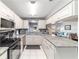 Updated kitchen with stainless steel appliances and white cabinets is open to the living area at 9015 Sw 94Th St # D, Ocala, FL 34481