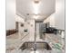 Open kitchen with stainless steel appliances and granite counters, seamlessly connecting to the dining area at 9015 Sw 94Th St # D, Ocala, FL 34481