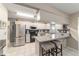 Modern kitchen boasts stainless steel appliances, granite countertops, and a functional island with seating at 9015 Sw 94Th St # D, Ocala, FL 34481