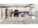 Modern kitchen with stainless steel appliances, granite countertops, and ample cabinet space at 9015 Sw 94Th St # D, Ocala, FL 34481