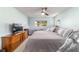 Cozy main bedroom features a ceiling fan, a window view, and an array of storage options at 9015 Sw 94Th St # D, Ocala, FL 34481