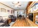 Cozy office with wood flooring, built-in shelves, comfortable seating, and a decorative stained glass window at 9015 Sw 94Th St # D, Ocala, FL 34481