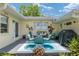 Outdoor patio features a round metal table with four cushioned chairs and a grill at 9015 Sw 94Th St # D, Ocala, FL 34481