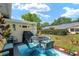 Relaxing patio area with outdoor seating, a grill, and views of the well-maintained backyard at 9015 Sw 94Th St # D, Ocala, FL 34481
