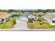 Attractive single-story home featuring mature landscaping and brick-paved driveway at 9290 Se 120Th Loop, Summerfield, FL 34491