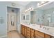 Bright bathroom features double sinks, a large mirror, and a separate glass shower at 9290 Se 120Th Loop, Summerfield, FL 34491