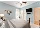 A quaint bedroom features a ceiling fan, wooden bed frame, and a window bringing in natural light at 9290 Se 120Th Loop, Summerfield, FL 34491