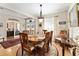 Elegant dining room with a wooden table, chairs, and decorative lighting at 9290 Se 120Th Loop, Summerfield, FL 34491