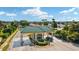 Welcoming gated entrance to a community, with manicured landscaping, a security gate, and a beautiful green roof at 9290 Se 120Th Loop, Summerfield, FL 34491