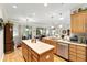 Bright kitchen with an island, stainless steel dishwasher, and an open floor plan at 9290 Se 120Th Loop, Summerfield, FL 34491