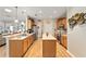 Functional kitchen featuring wood cabinetry, an island, and stainless steel appliances at 9290 Se 120Th Loop, Summerfield, FL 34491