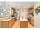 Spacious kitchen featuring wood cabinets, stainless steel appliances, and an island at 9290 Se 120Th Loop, Summerfield, FL 34491