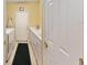 The yellow laundry room offers cabinets, countertop, washer, dryer, and a door to the garage at 9290 Se 120Th Loop, Summerfield, FL 34491