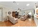 Comfortable living room with wood floors, entertainment center, and cozy seating at 9290 Se 120Th Loop, Summerfield, FL 34491