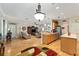 Spacious open floor plan of kitchen and living room with recessed lighting and wood floors at 9290 Se 120Th Loop, Summerfield, FL 34491