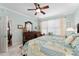 Well-lit bedroom with a ceiling fan, wood furniture, and neutral color scheme at 9290 Se 120Th Loop, Summerfield, FL 34491