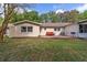 Exterior backyard view of the home featuring a patio, green lawn, and lush trees at 9331 Sw 84Th Ter # C, Ocala, FL 34481