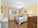 Bright bedroom with a ceiling fan, wood-look floors, and a window for natural light at 9331 Sw 84Th Ter # C, Ocala, FL 34481