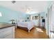 Inviting bedroom with a comfortable bed, ceiling fan, ample natural light, and hardwood floors at 9331 Sw 84Th Ter # C, Ocala, FL 34481