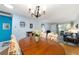 Charming dining room boasts a classic chandelier and floral-patterned chairs at 9331 Sw 84Th Ter # C, Ocala, FL 34481