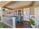 Inviting front porch featuring two blue Adirondack chairs and decorative plants and flowers at 9331 Sw 84Th Ter # C, Ocala, FL 34481