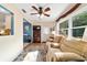 Cozy living room featuring a ceiling fan, recliner sofa, and a colorful floral rug on hardwood floor at 9331 Sw 84Th Ter # C, Ocala, FL 34481