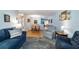 Open-concept living room and dining area with blue sofa and view into the kitchen at 9331 Sw 84Th Ter # C, Ocala, FL 34481