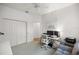 Well-lit bedroom featuring a closet, a door, and a workstation with dual monitors at 9579 Sw 195 Cir, Dunnellon, FL 34432