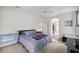 Cozy bedroom with soft carpet, ceiling fan, and ensuite bathroom at 9579 Sw 195 Cir, Dunnellon, FL 34432