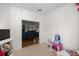 Bright bedroom with an entryway to another room with wood floors and brown couches at 9579 Sw 195 Cir, Dunnellon, FL 34432