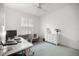 Bright bedroom with a large window, white plantation shutters, and comfortable workstation at 9579 Sw 195 Cir, Dunnellon, FL 34432