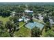 Aerial view of community pool, tennis and shuffleboard courts surrounded by lush trees at 9579 Sw 195 Cir, Dunnellon, FL 34432