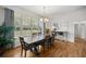 Bright dining room with large windows, chandelier, and seating for eight is perfect for Gathering dinners at 9579 Sw 195 Cir, Dunnellon, FL 34432