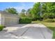 Spacious driveway leading to a two-car garage, with landscaping at 9579 Sw 195 Cir, Dunnellon, FL 34432