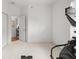 A view of an exercise room with exercise equipment with an entry to another room at 9579 Sw 195 Cir, Dunnellon, FL 34432