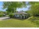 Rear exterior view highlighting the storage shed, landscaping, and brick path at 9579 Sw 195 Cir, Dunnellon, FL 34432