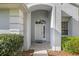 Inviting front entrance with tiled porch, decorative columns, and sidelight windows at 9579 Sw 195 Cir, Dunnellon, FL 34432