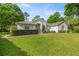 Charming single-story home with a well-manicured lawn and lush landscaping at 9579 Sw 195 Cir, Dunnellon, FL 34432
