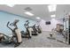 Brightly lit gym featuring multiple treadmills, weight machines and blue carpeting at 9579 Sw 195 Cir, Dunnellon, FL 34432