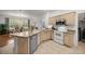 Well-lit kitchen boasts stainless steel appliances and a charming breakfast bar overlooking the dining area at 9579 Sw 195 Cir, Dunnellon, FL 34432