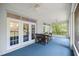 Screened in patio featuring french doors, ceiling fans, and outdoor furniture at 9579 Sw 195 Cir, Dunnellon, FL 34432
