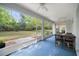 Enclosed patio featuring a view of the yard, ceiling fans, and outdoor furniture at 9579 Sw 195 Cir, Dunnellon, FL 34432