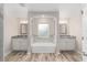 Bright bathroom featuring double sinks, white cabinets, granite countertops, and soaking tub at 9709 Sw 40Th Ct, Ocala, FL 34476